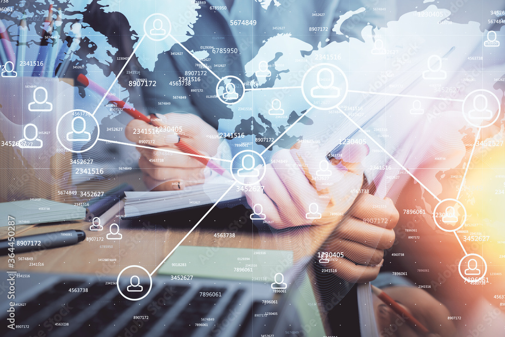 Social network theme hologram over hands taking notes background. Concept of global international people connect. Double exposure Social network theme hologram over hands taking notes background. Concept of global international people connect. Double exposure