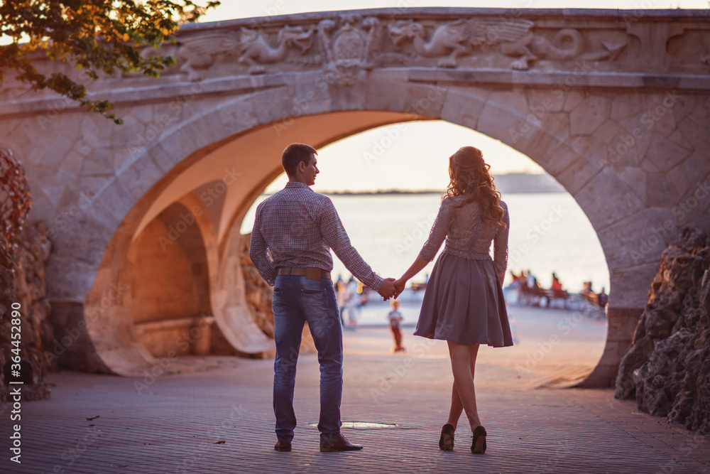 Young couple in love outdoor.Stunning sensual outdoor portrait of young stylish fashion couple posing in summer in street Young couple in love outdoor.Stunning sensual outdoor portrait of young stylish fashion couple posing in summer in street