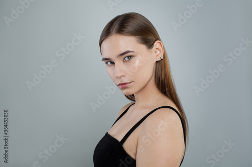 Young face. Healthy model woman with clear skin and straight hair. Skincare and facial treatment concept