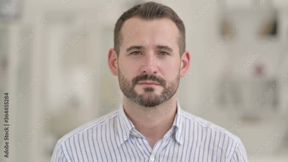 Portrait of Attractive Young Man Looking at Camera Portrait of Attractive Young Man Looking at Camera