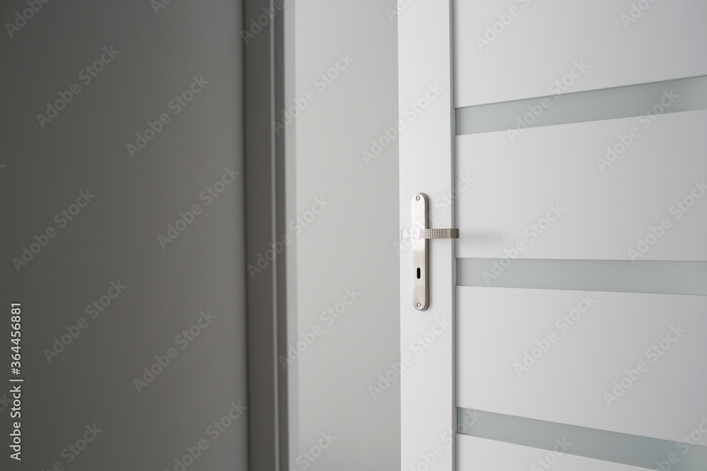New apartment studio wooden door. Interior modern architecture background. Indoor empty house. Metal door handle room enterance. Buying house symbolic door open. New apartment studio wooden door. Interior modern architecture background. Indoor empty house. Metal door handle room enterance. Buying house symbolic door open.