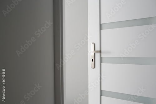 New apartment studio wooden door. Interior modern architecture background. Indoor empty house. Metal door handle room enterance. Buying house symbolic door open.