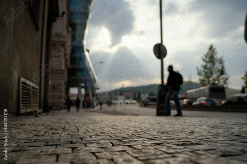 Prague street with dancing house blurred in the background with people walking. © David Ferencik