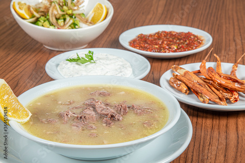 Obraz na płótnie Turkish Traditional Soup with bread on white rustic wooden background, kelle, paca corbasi