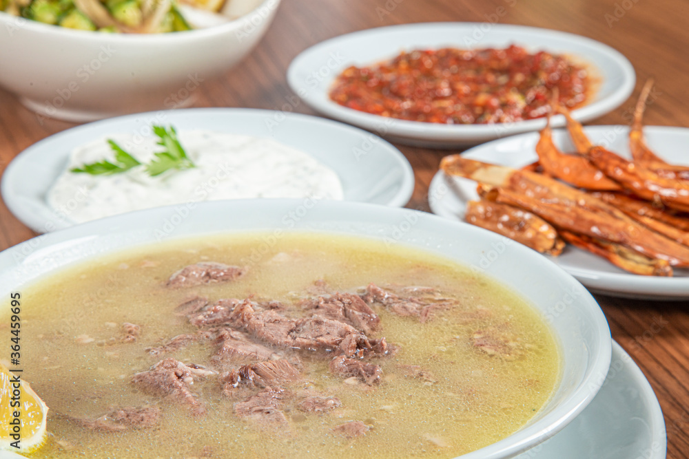 Turkish Traditional Soup with bread on white rustic wooden background, kelle, paca corbasi. Turkish Traditional Soup with bread on white rustic wooden background, kelle, paca corbasi.