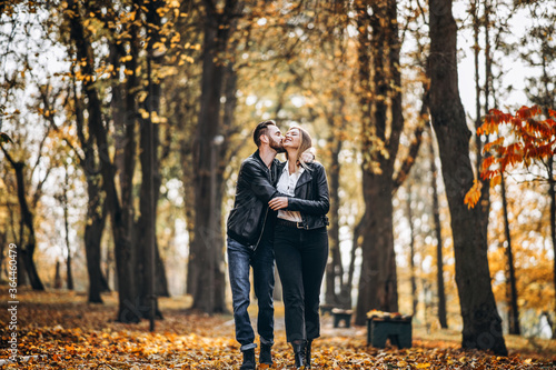 Portrait of a happy loving couple walking outdoor in the autumn park © bedya