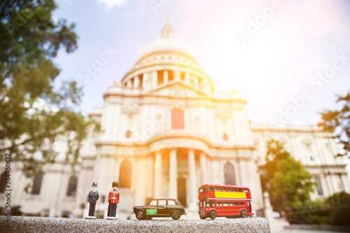 Figurines of London officers and public transports with St. Paul's Cathedral in background