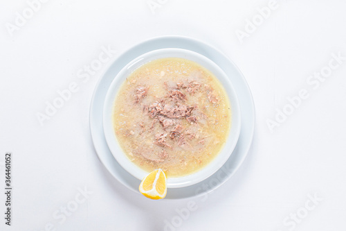 Turkish Traditional Soup with bread on white rustic wooden background, kelle, paca corbasi.