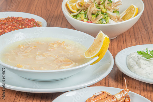 Turkish Traditional Soup with bread on white rustic wooden background, iskembe corbasi.