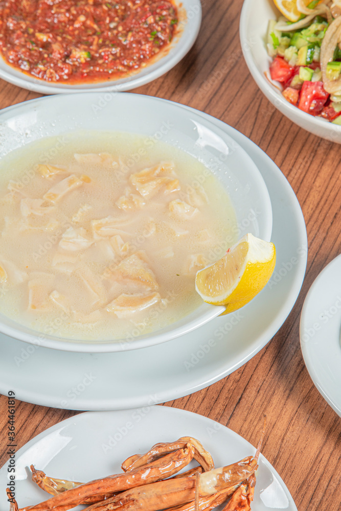 Turkish Traditional Soup with bread on white rustic wooden background, iskembe corbasi. Turkish Traditional Soup with bread on white rustic wooden background, iskembe corbasi.
