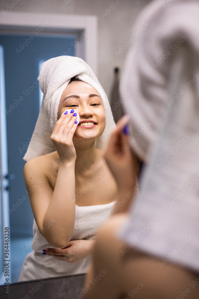 Beautiful asian woman bare skin in white bathrobe wash and clean facial with care in morning freshness sunlight Beautiful asian woman bare skin in white bathrobe wash and clean facial with care in morning freshness sunlight