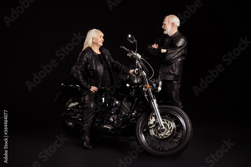 Portrait of his he her she nice attractive trendy cheerful cheery grey-haired couple friends hipsters enjoying meeting garage chopper party appointment isolated on black color background
