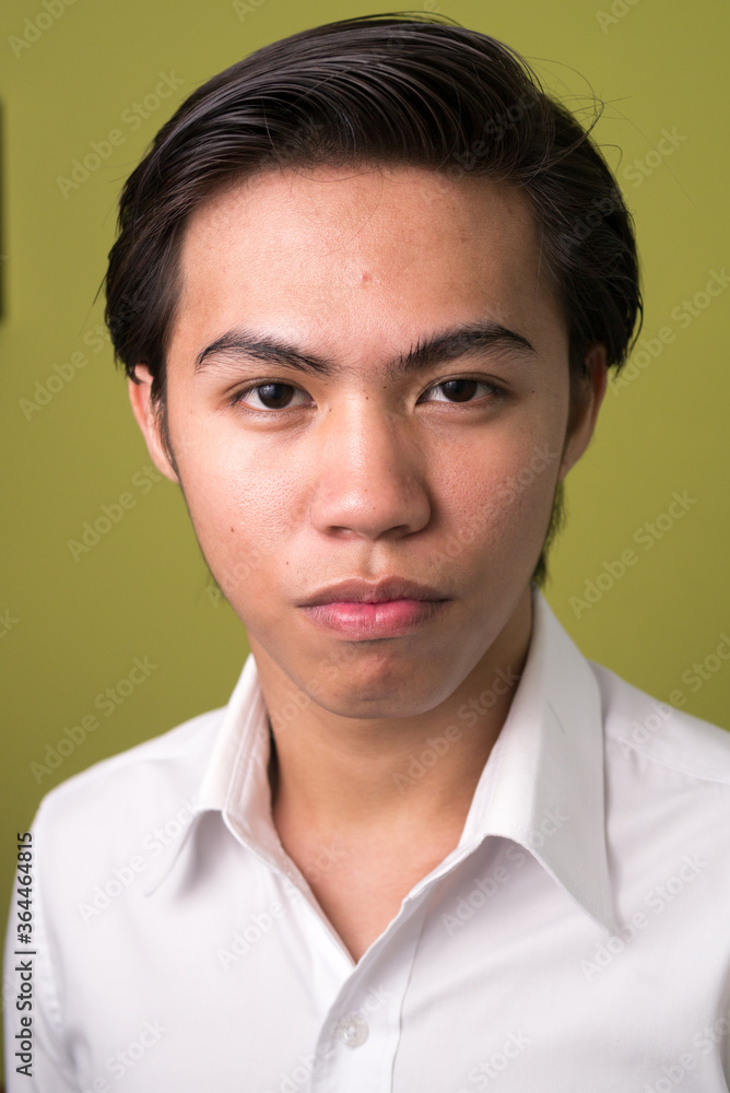 Face of young Filipino businessman looking at camera Face of young Filipino businessman looking at camera