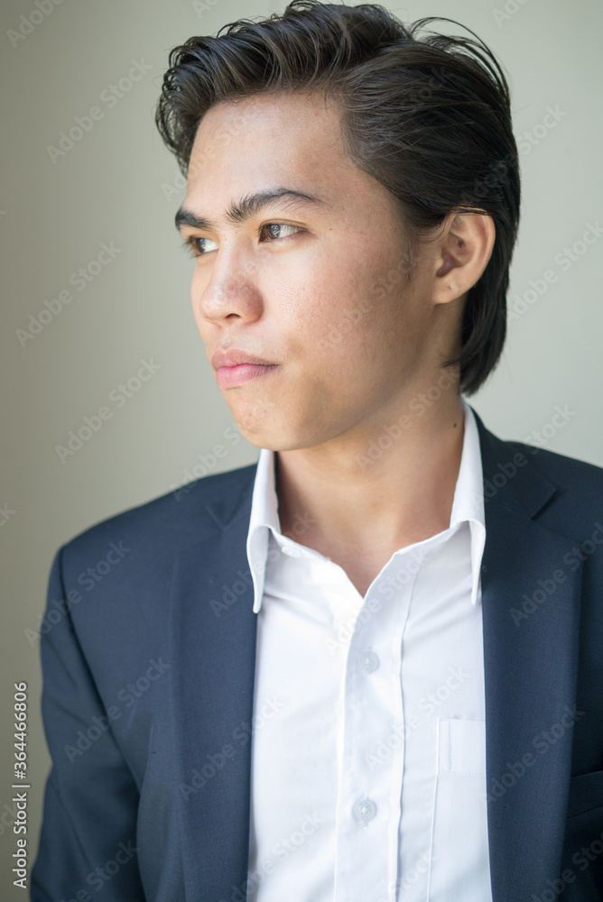 Face of young Filipino businessman in suit thinking Face of young Filipino businessman in suit thinking