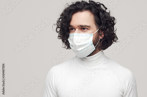 Man in medical mask looking away © kegfire