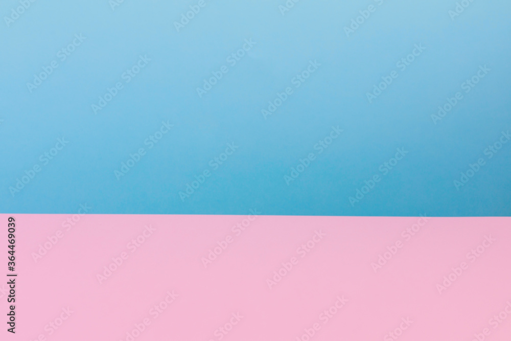 The background is made up of blue and pink pastel paper tones. Blurry. Copy space.