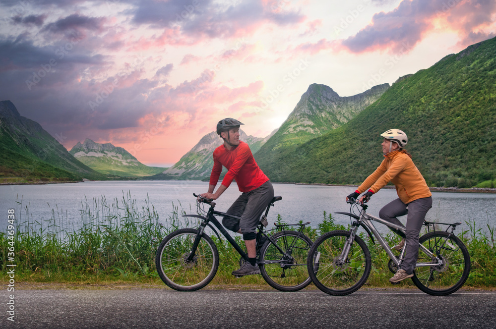 two cyclists relax biking outdoors in Norway