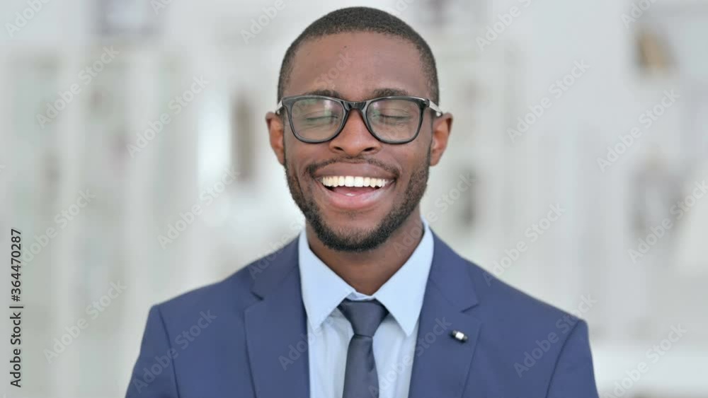 Portrait of Cheerful African Businessman Smiling at the Camera Portrait of Cheerful African Businessman Smiling at the Camera
