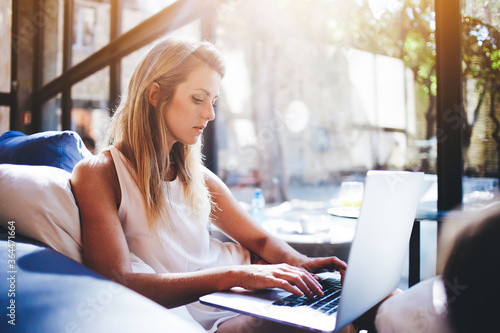 Charming European woman chatting in social network via net-book while sitting in modern interior, beautiful young female searching work via internet on laptop computer during free time in weekend Free Download Charming European woman chatting in social network via net-book while sitting in modern interior, beautiful young female searching work via internet on laptop computer during free time in weekend - GFXLoad