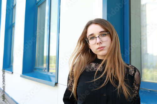Teenager girl against backdrop of new building © Arkady Chubykin