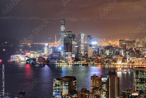 Colorful night aerial view of Victoria Harbor and Hong Kong