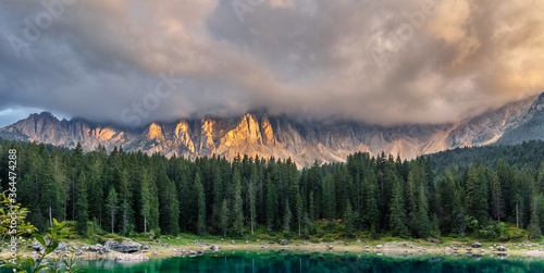Fototapeta Naklejka Na Ścianę i Meble -  Awesome Dolomites Alps with mountain lake Karersee and Overcast sky.  Amazing morning scene of Dolomiti Alps, Province of Bolzano, South Tyrol, Italy, Europe. Wonderful Carezza lake.