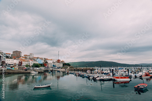 Old European City and Harbor with Many Boats and Cloudy Sky in Galicia, Spain