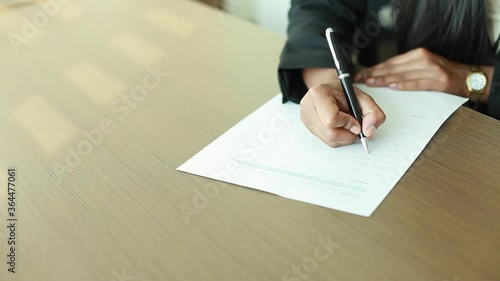 Closeup footage of woman's hand filling loan application form