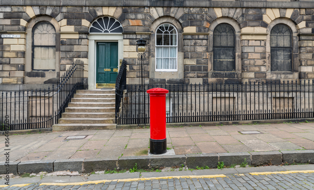 Sidewalk, facades and typical red british postbox Sidewalk, facades and typical red british postbox