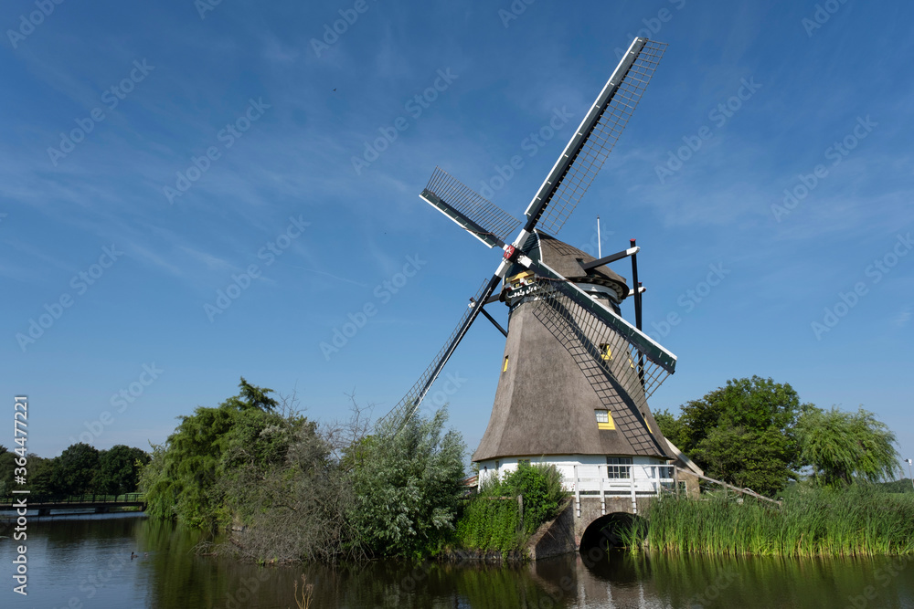 Traditional dutch windmill near the canal. Netherlands.