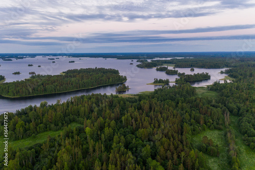 Sunrise over the islands of the water world in Karelia. Aerial view. © alexkazachok