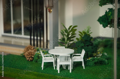 White outdoor table set beside the house