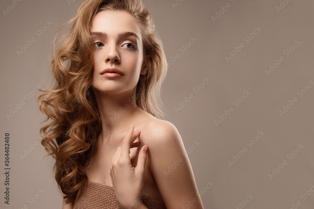 Young woman with perfect skin. Studio portrait. Natural nude makeup. Girl with beautiful hair. Young woman with perfect skin. Studio portrait. Natural nude makeup. Girl with beautiful hair.