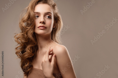 Young woman with perfect skin. Studio portrait. Natural nude makeup. Girl with beautiful hair.
