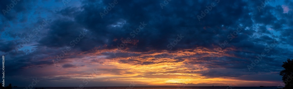 Beautiful sunset with colored clouds over the sea