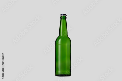 Empty green colored beer bottle. One object isolated on white studio background. Concept of beer, beverage, entertainment and alcohol. Copyspace for your bar, restaurant, brewery or shop advertising.