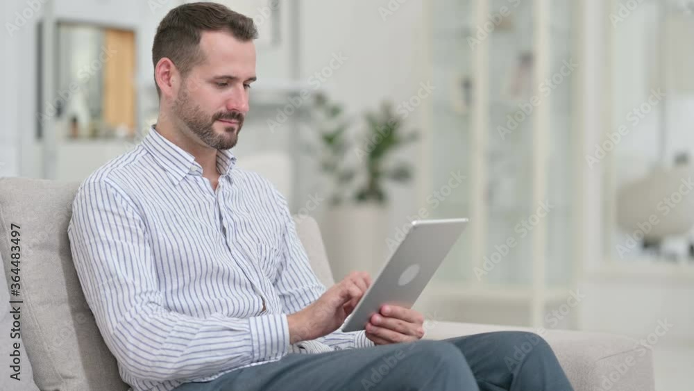 Professional Young Man using Tablet at Home Professional Young Man using Tablet at Home