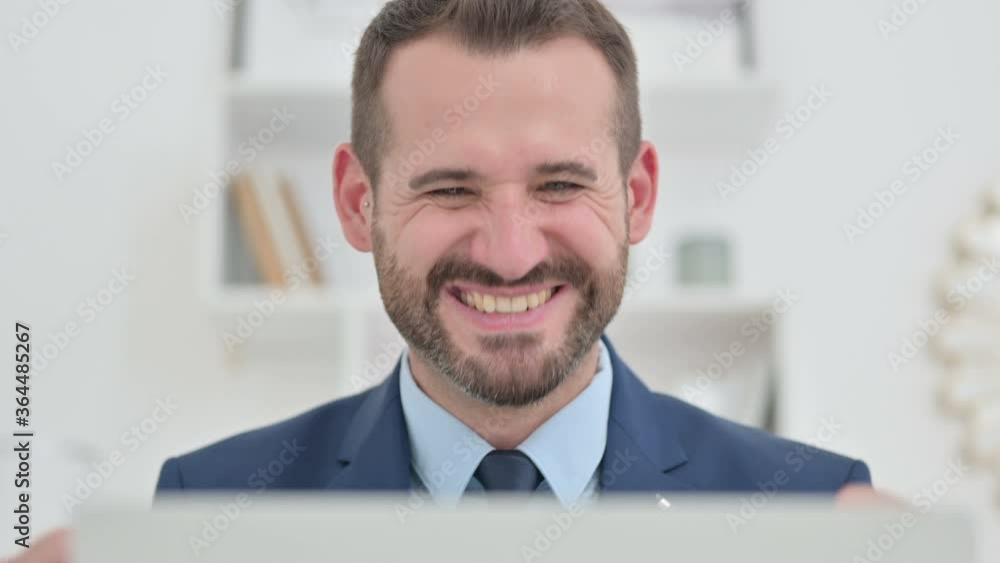 Excited Businessman Celebrating Success on Laptop Excited Businessman Celebrating Success on Laptop