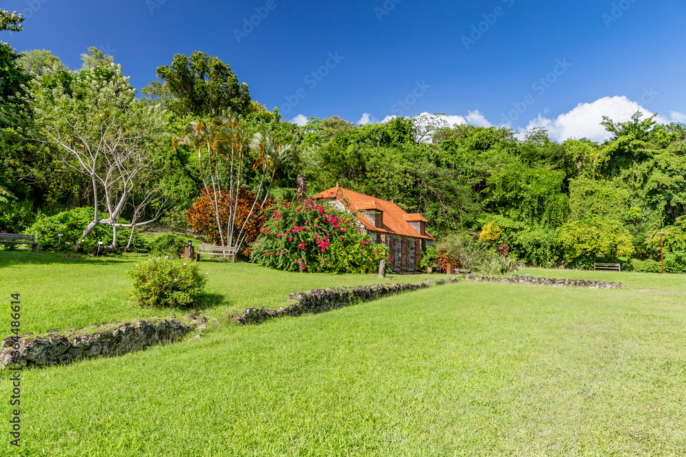 Green manicured lawn with ruins of sugar mill in the background it Trois Ilets, Martinique, France Green manicured lawn with ruins of sugar mill in the background it Trois Ilets, Martinique, France