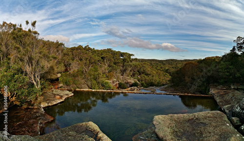 Beautiful view of Wattamolla dam with reflections of trees and blue cloudy sky, Wattamolla creek, Royal National Park, New South Wales, Australia