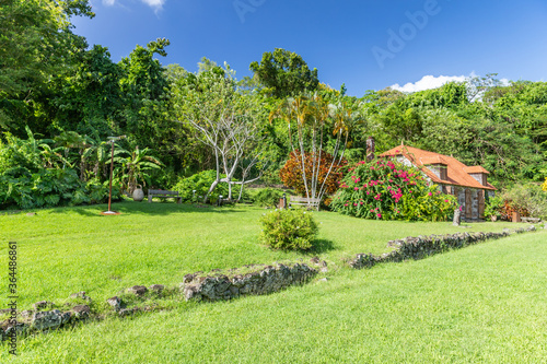 Green manicured lawn with ruins of sugar mill in the background it Trois Ilets, Martinique, France photo