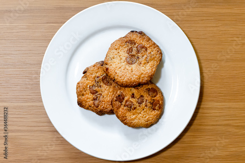 Three cookies on a white plate.