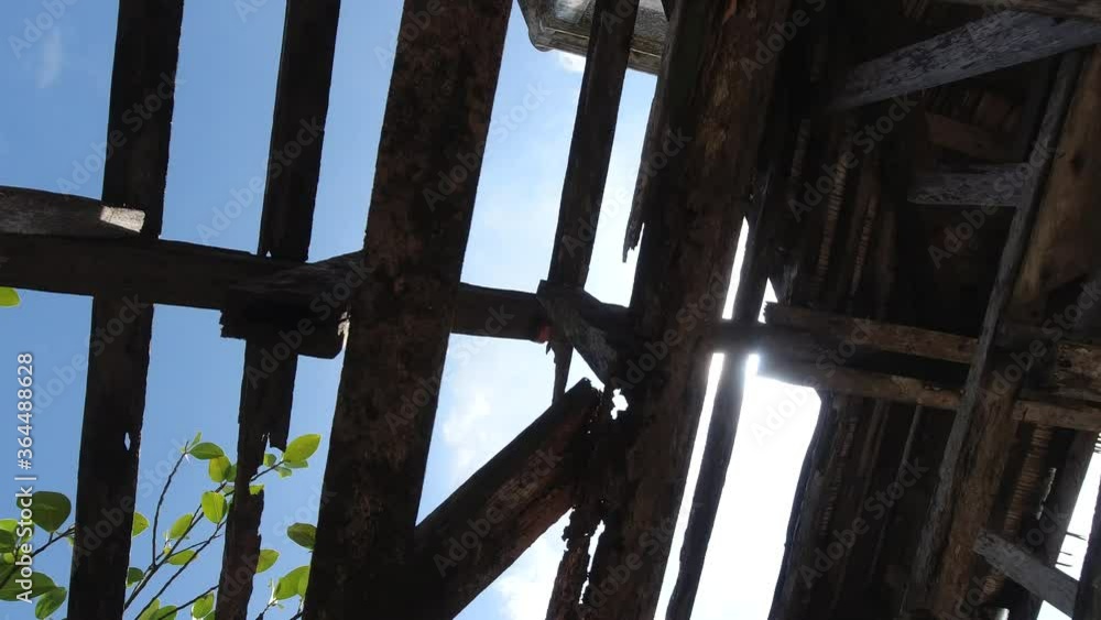 Bottom view of the roof of an old building with wooden structures against the sky. Destroyed wooden roof in the abandoned building. Steadicam shot. Bottom view of the roof of an old building with wooden structures against the sky. Destroyed wooden roof in the abandoned building. Steadicam shot.