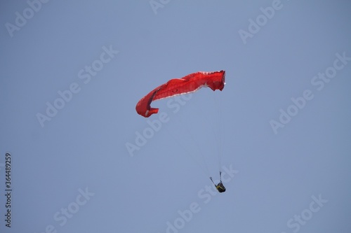 Closeup shot of a red paraplane on an empty sky photo