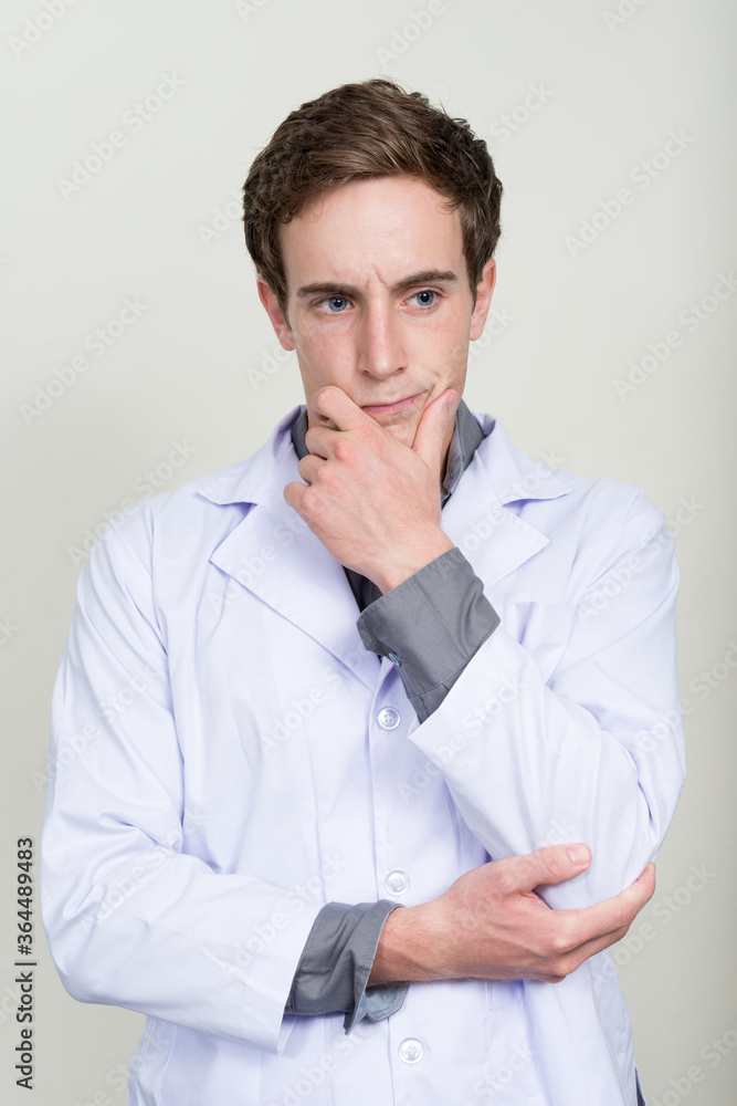 Portrait of young handsome man doctor thinking Portrait of young handsome man doctor thinking
