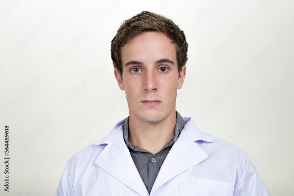Face of young handsome man doctor looking at camera Face of young handsome man doctor looking at camera