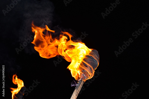 Burning flame torch in night during an event photo