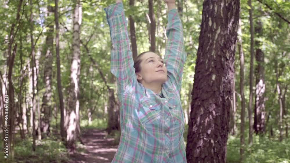 woman in the forest reaches for the sky and takes a deep breath. woman in the forest reaches for the sky and takes a deep breath.