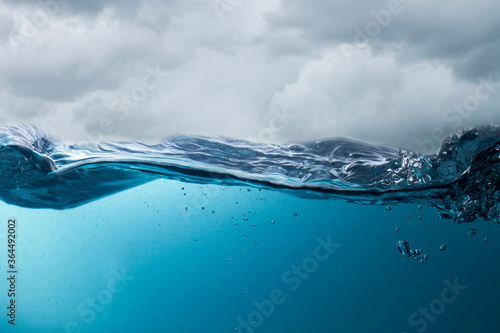 The deep blue sea at the time of the storm can be seen from under the water. Abstract wave blur under water photo