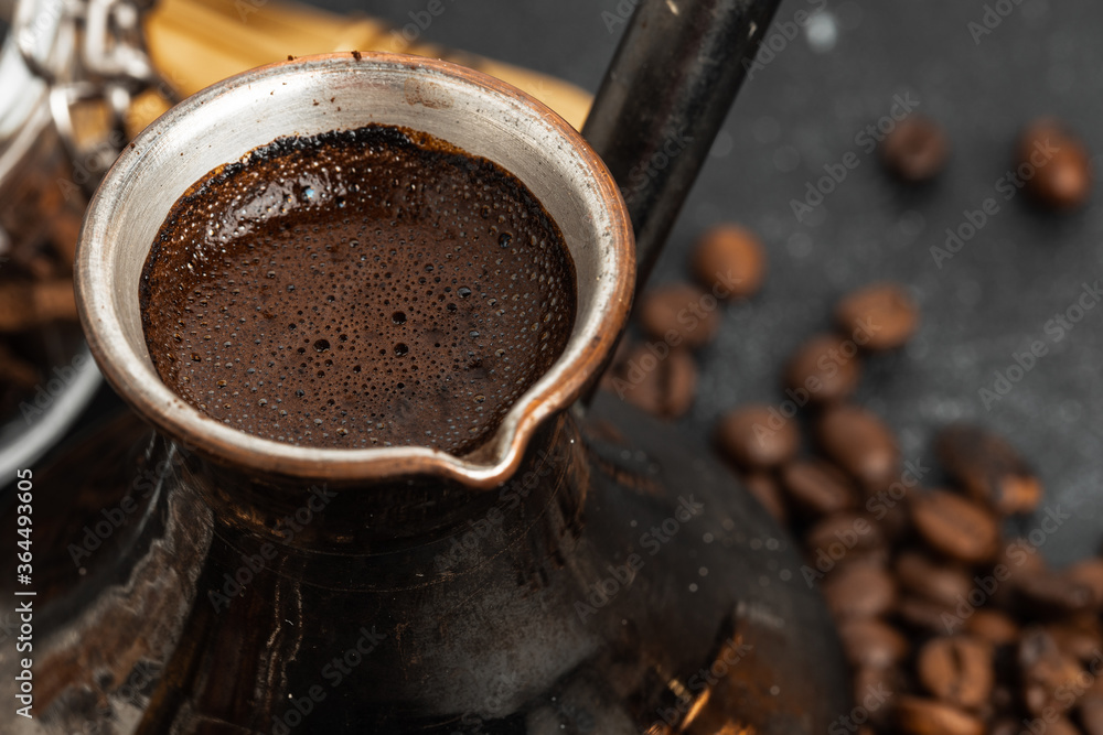 Coffee beans and turk on dark surface Coffee beans and turk on dark surface